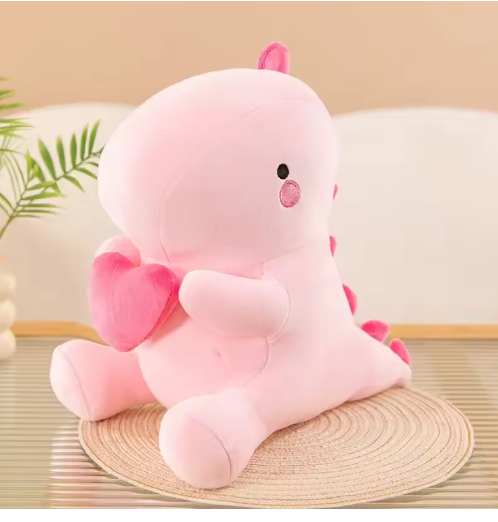 Weighted dinosaur plushie on a cozy college desk